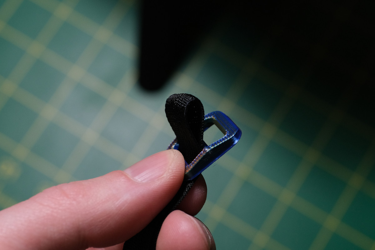 Threading the strap loop through the slide from bottom to top